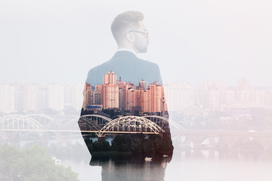 Double exposure of businessman and city landscape