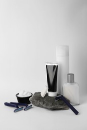 Different men's shaving accessories on light background