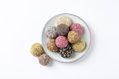 Photo of Different delicious vegan candy balls on white background, top view