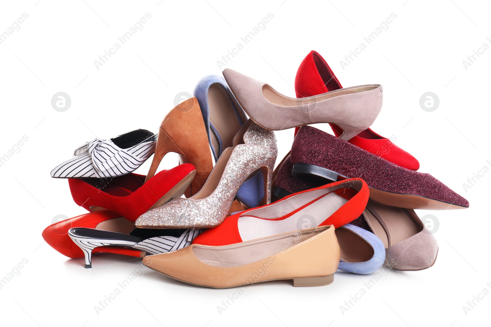 Photo of Pile of female shoes on white background