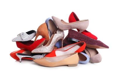 Photo of Pile of female shoes on white background