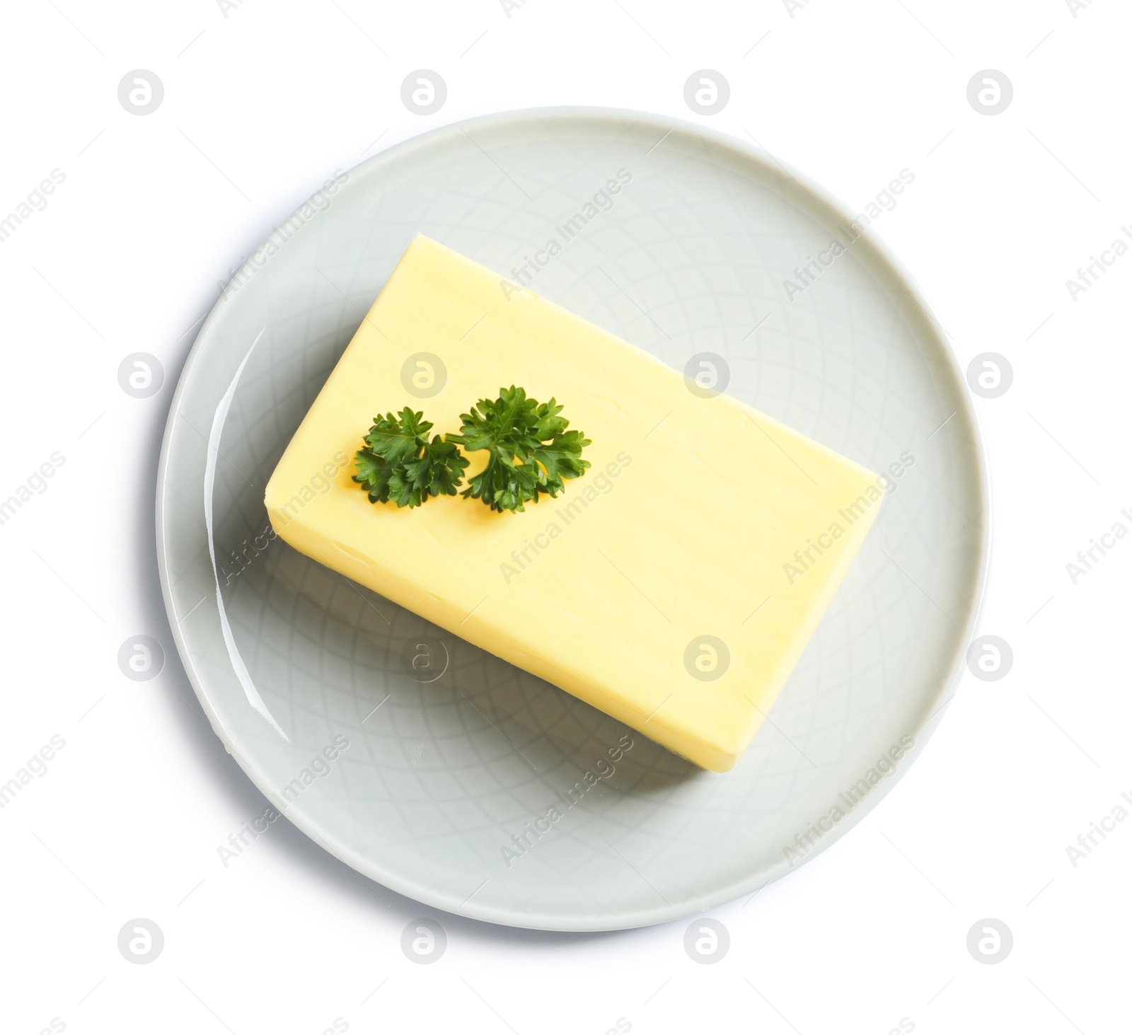 Photo of Ceramic plate with block of fresh butter on white background, top view