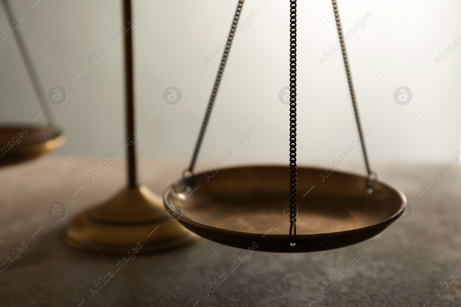 Photo of Scales of justice on table, closeup. Law concept