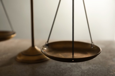 Scales of justice on table, closeup. Law concept