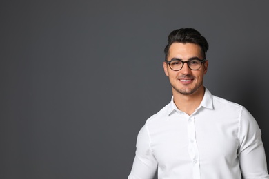 Photo of Portrait of handsome young man and space for text on black background