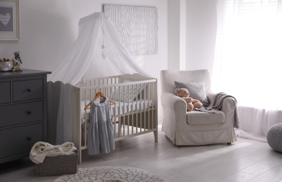 Baby room interior with comfortable crib and armchair