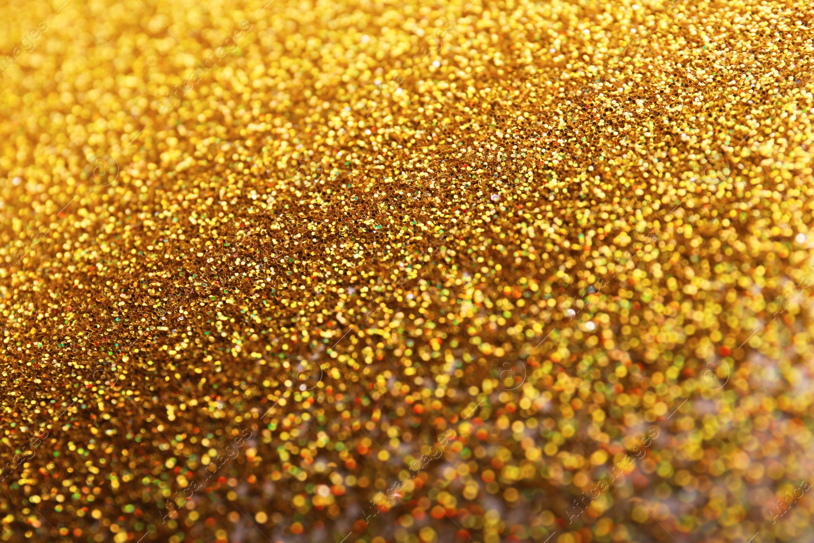 Photo of Closeup view of sparkling golden glitter background