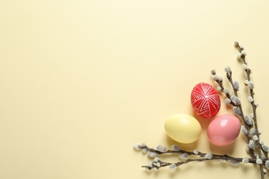 Photo of Flat lay composition with painted Easter eggs on color background, space for text