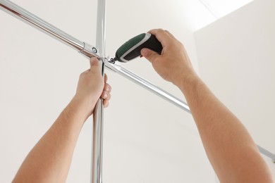 Worker installing new metal pipes indoors, closeup