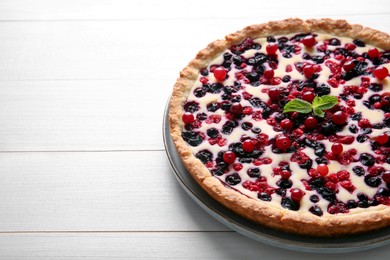 Photo of Delicious currant pie on white wooden table, space for text