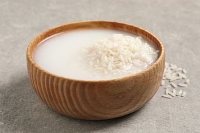 Photo of Rice soaked in water on light grey table