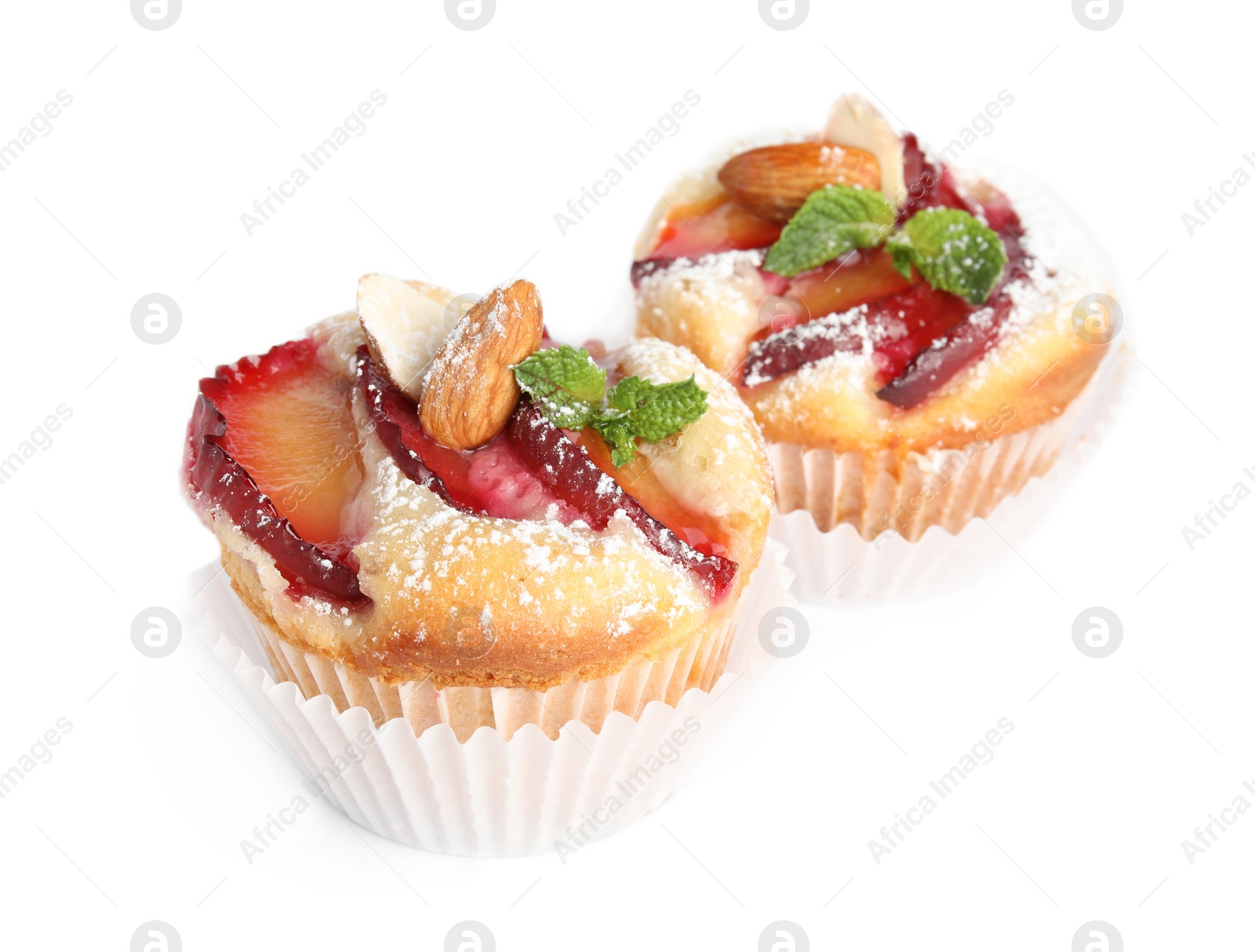 Photo of Delicious cupcakes with plums isolated on white