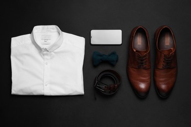Photo of Flat lay composition with stylish men's clothes and accessories on black background
