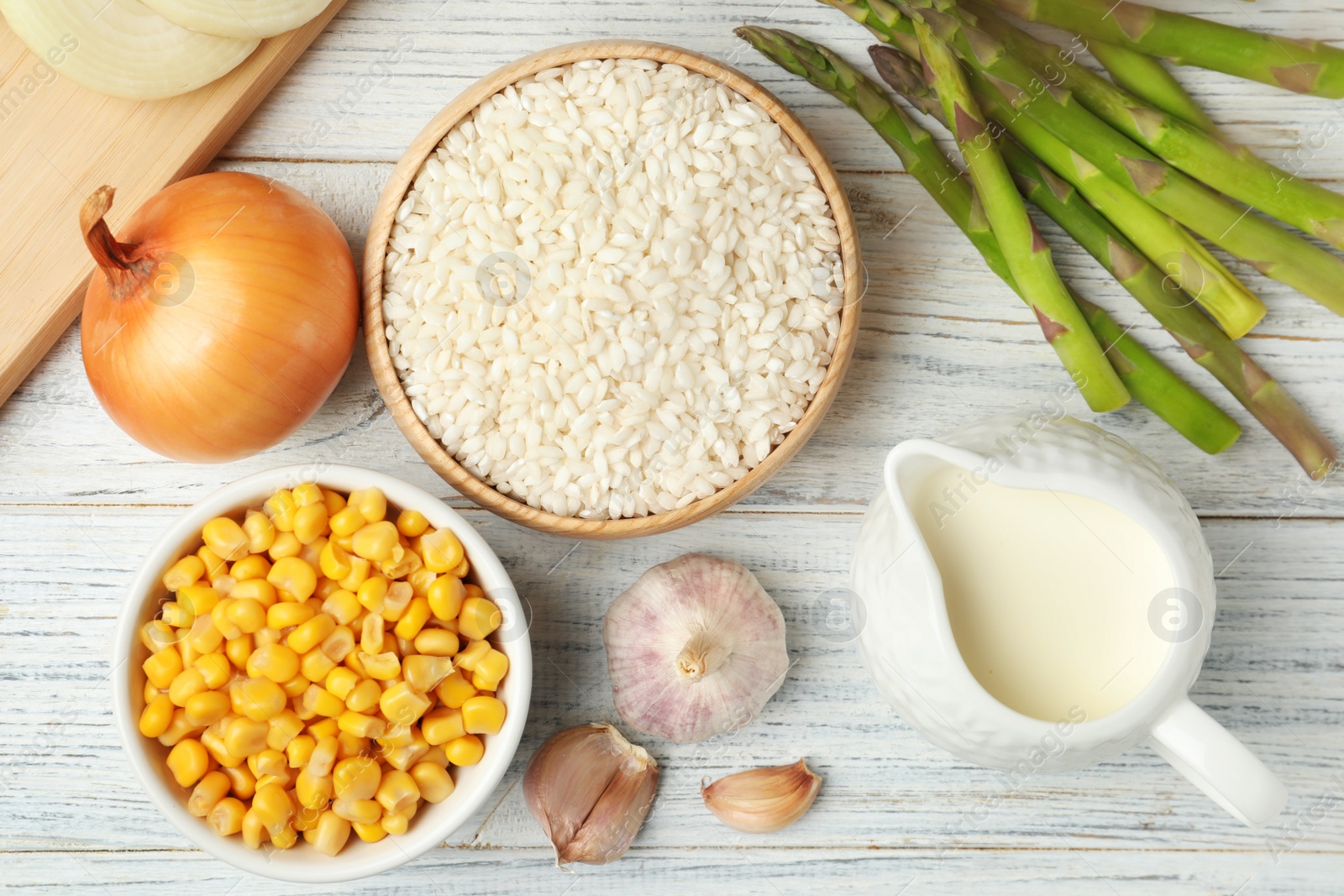 Photo of Flat lay composition with different ingredients on white wooden table. Risotto recipe