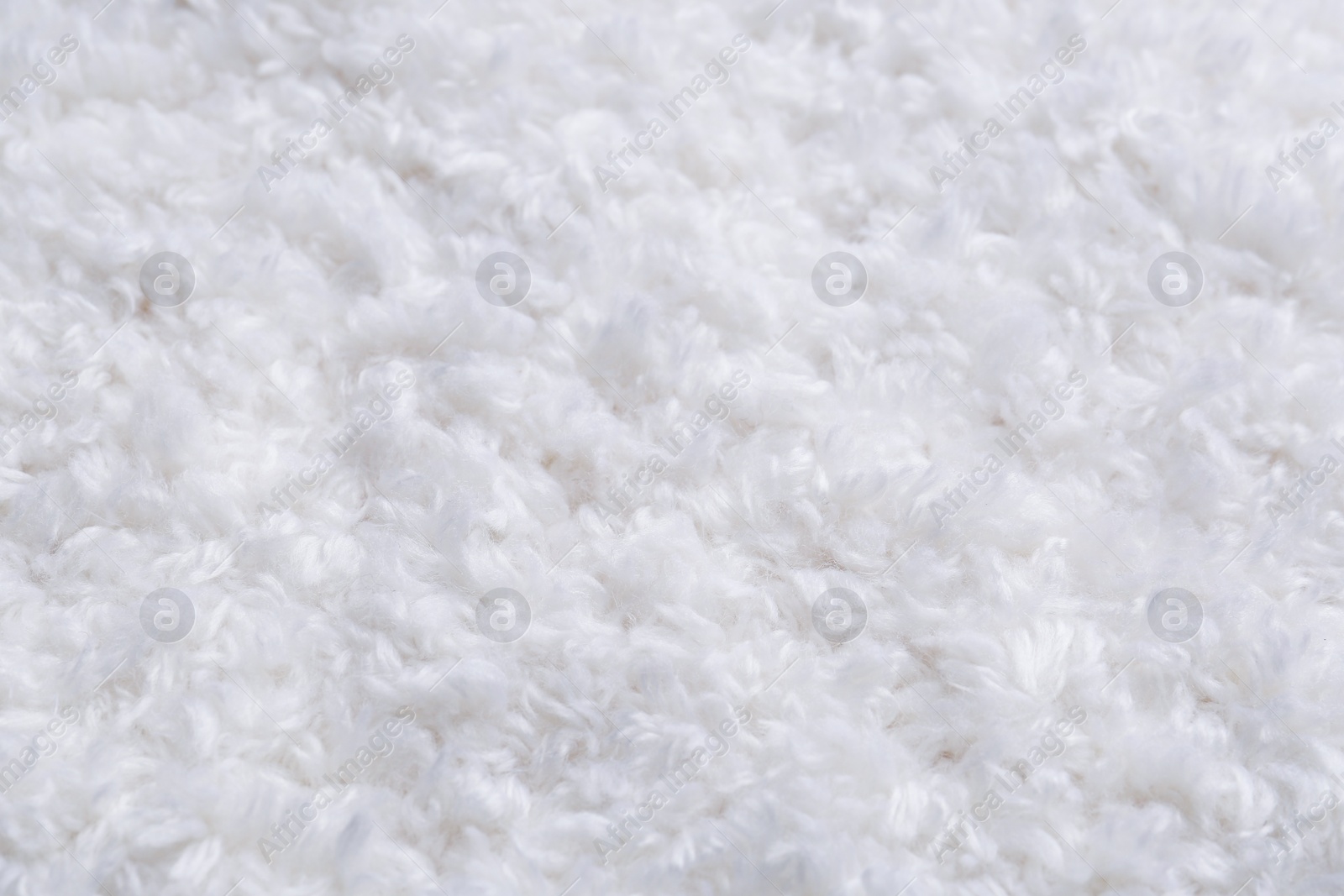 Photo of Soft white knitted fabric as background, closeup