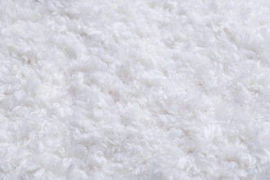 Photo of Soft white knitted fabric as background, closeup