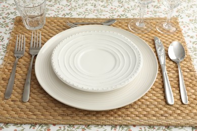 Photo of Stylish setting with cutlery, plates and glasses on table