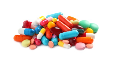 Photo of Pile of different colorful pills on white background