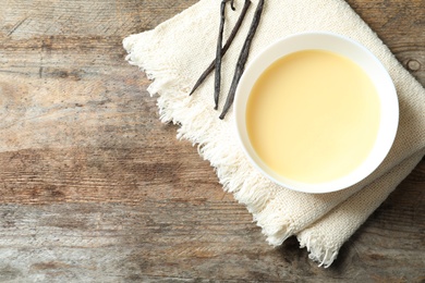 Bowl of condensed milk served on table, top view with space for text. Dairy products