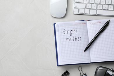 Notepad with words Single Mother on white background, flat lay and space for text