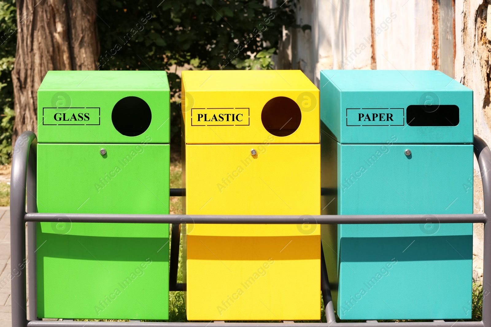 Photo of Waste sorting bins on city street. Recycling concept