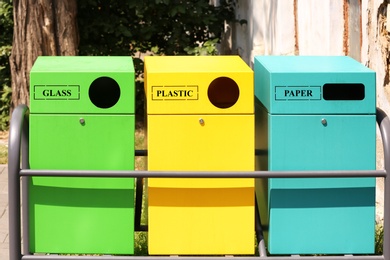 Waste sorting bins on city street. Recycling concept