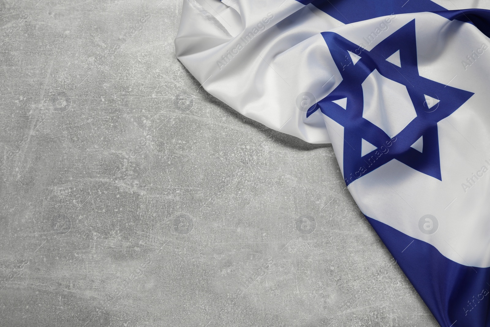 Photo of Flag of Israel on grey textured background, above view and space for text. National symbol