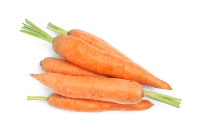 Photo of Pile of ripe juicy carrots on white background, top view