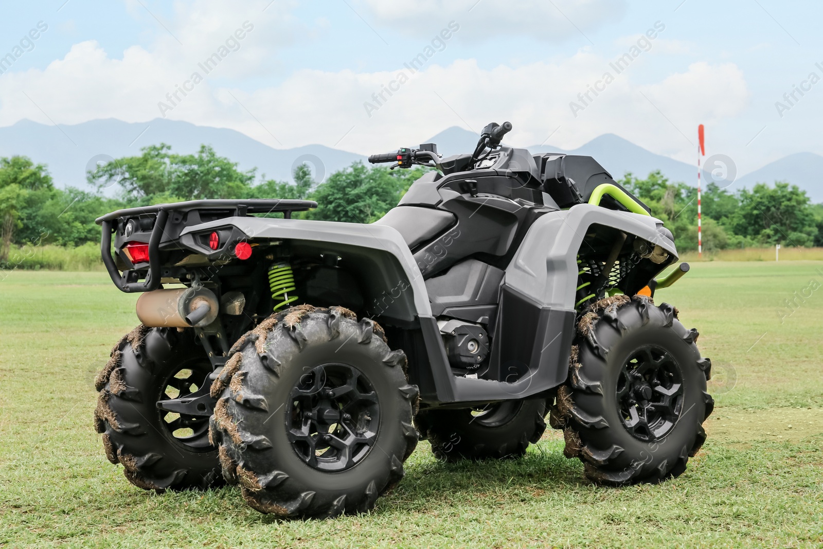 Photo of Modern quad bike on green grass outdoors