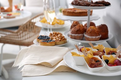 Variety of snacks on white table in buffet style indoors