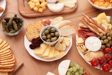Photo of Assorted appetizers served on wooden table, above view