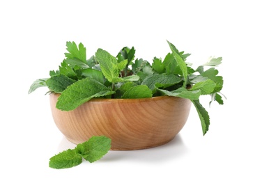 Photo of Bowl with fresh green herbs on white background