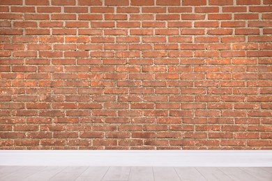 Room with brick wall and wooden floor