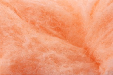 Orange cotton candy as background, closeup view