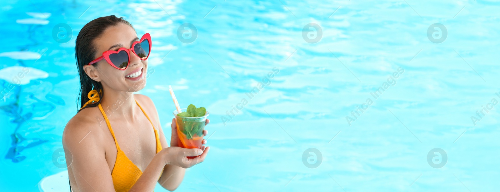 Image of Woman with glass of refreshing drink in swimming pool, space for text. Banner design