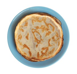 Photo of Stack of delicious crepes on plate against white background, top view