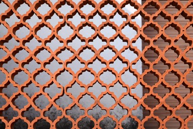 Photo of Closeup view of ornate brown fence outdoors