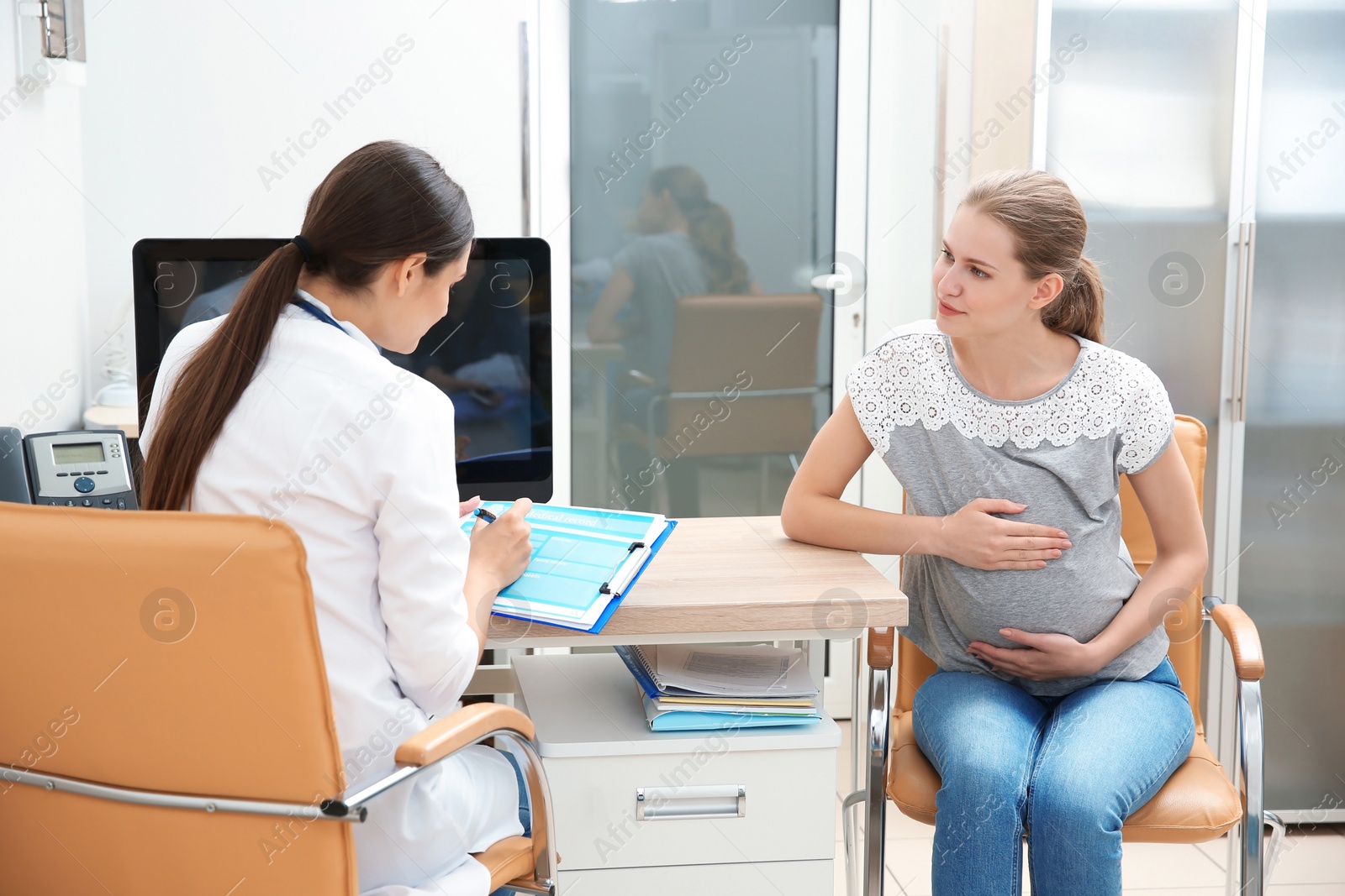 Photo of Pregnant woman having appointment at gynecologist office