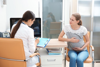 Photo of Pregnant woman having appointment at gynecologist office