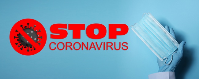 Image of Doctor holding medical mask near text Stop Coronavirus on light blue background, closeup. Protective measures during pandemic