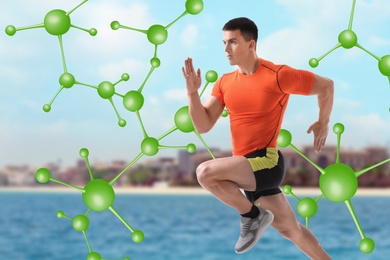Metabolism concept. Molecular chain illustration and athletic young man running  near sea on sunny day 