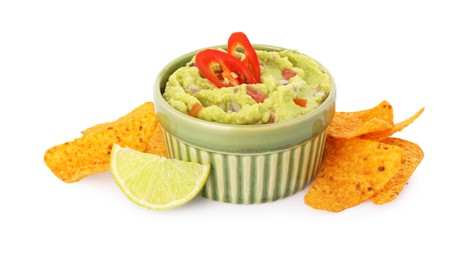 Bowl of delicious guacamole, lime and nachos chips isolated on white