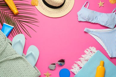Photo of Frame made with different beach objects on pink background, flat lay. Space for text