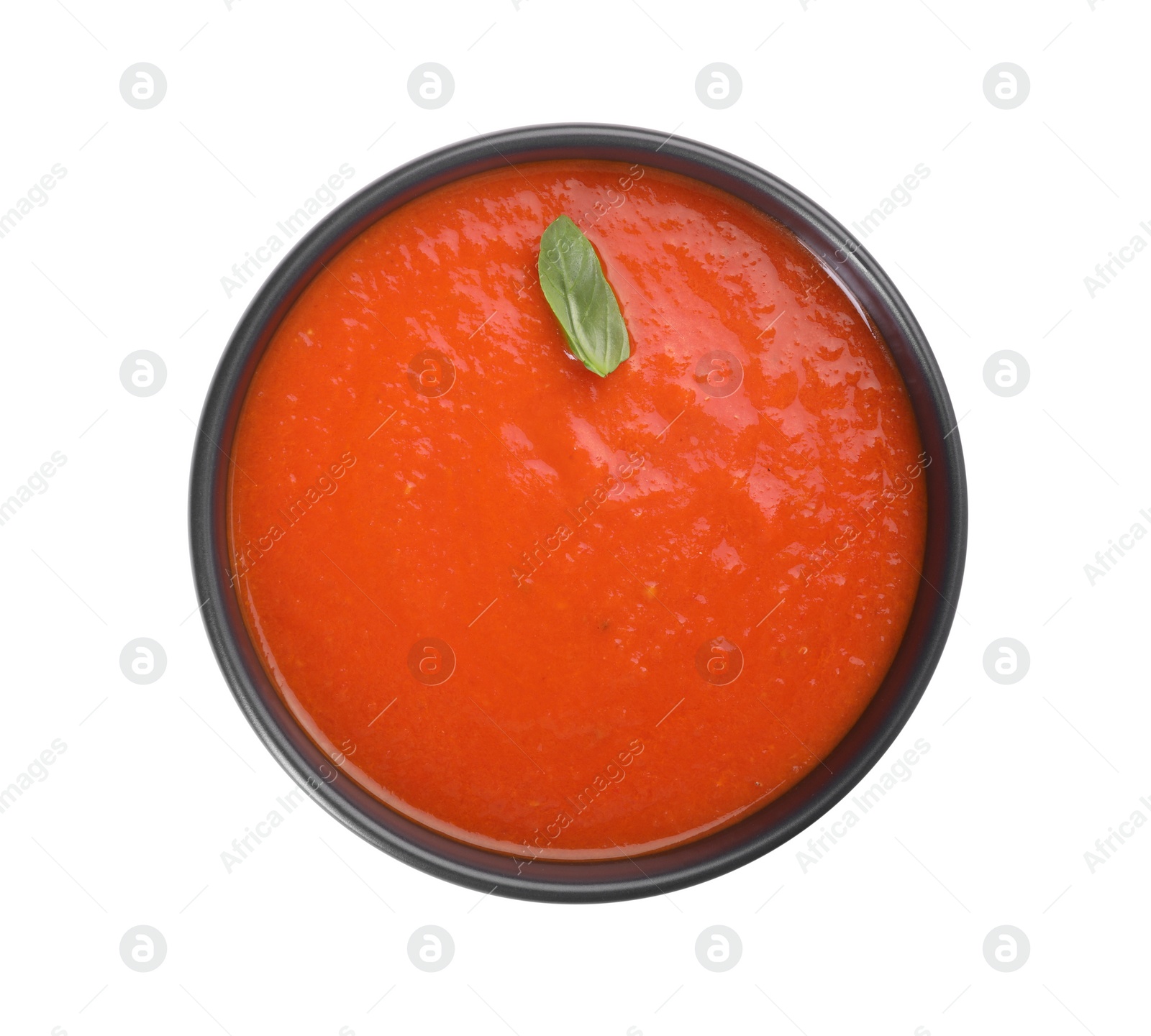 Photo of Delicious tomato cream soup in bowl isolated on white, top view