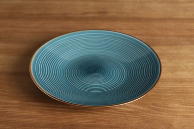 Photo of Elegant new empty plate on wooden table