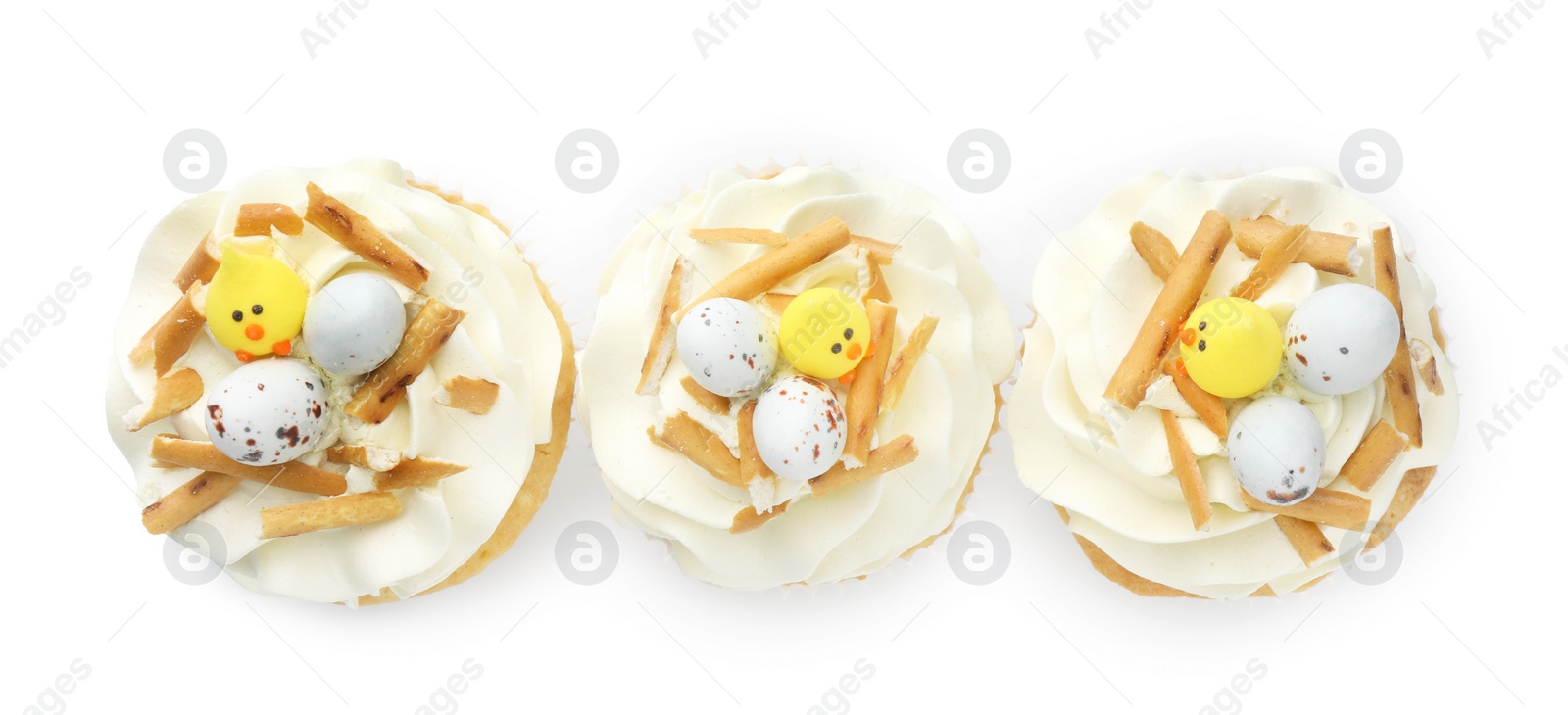 Photo of Tasty Easter cupcakes with vanilla cream isolated on white, top view