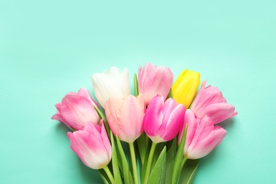 Photo of Spring tulips on color background, top view. International Women's Day