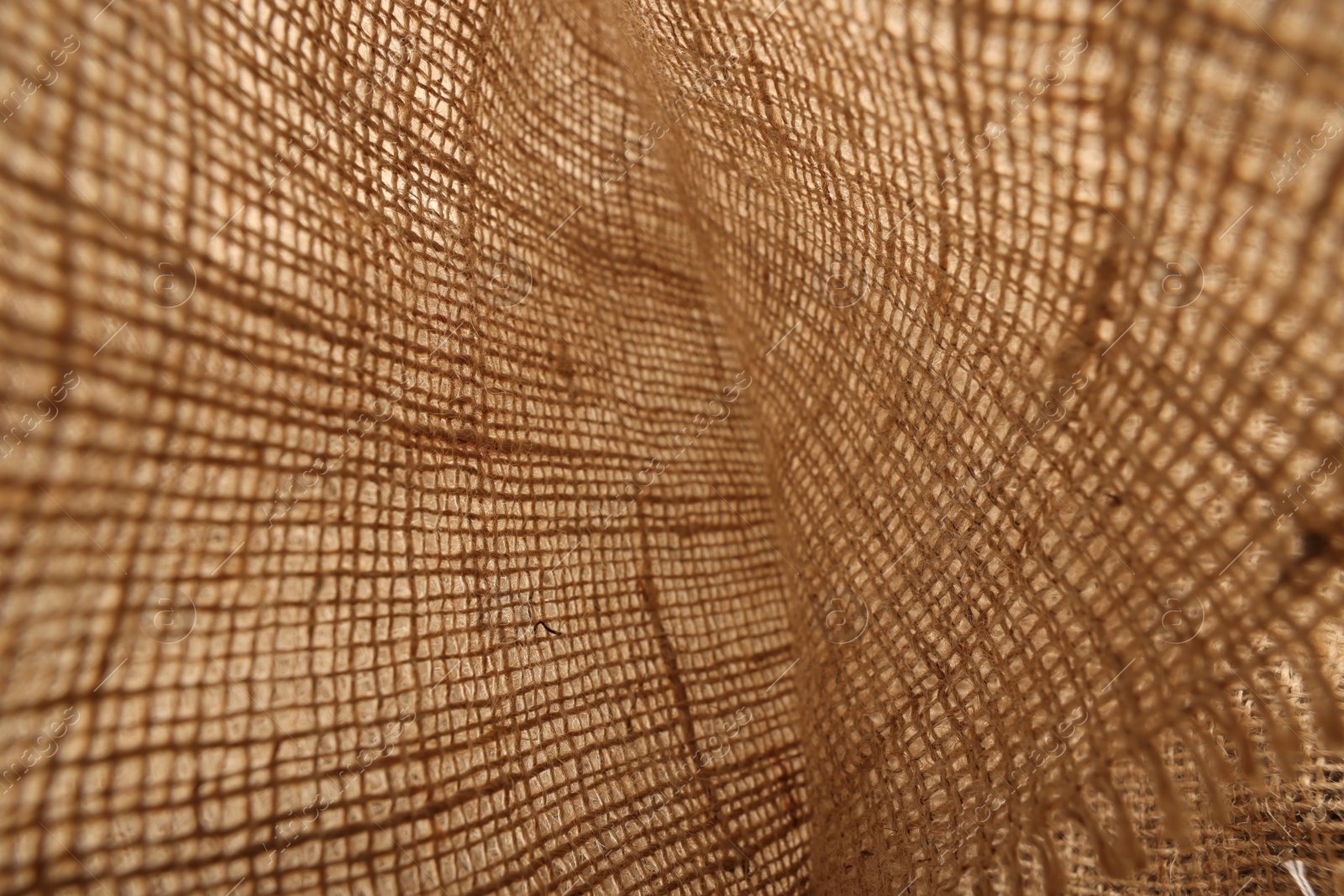 Photo of Texture of natural burlap fabric as background, closeup