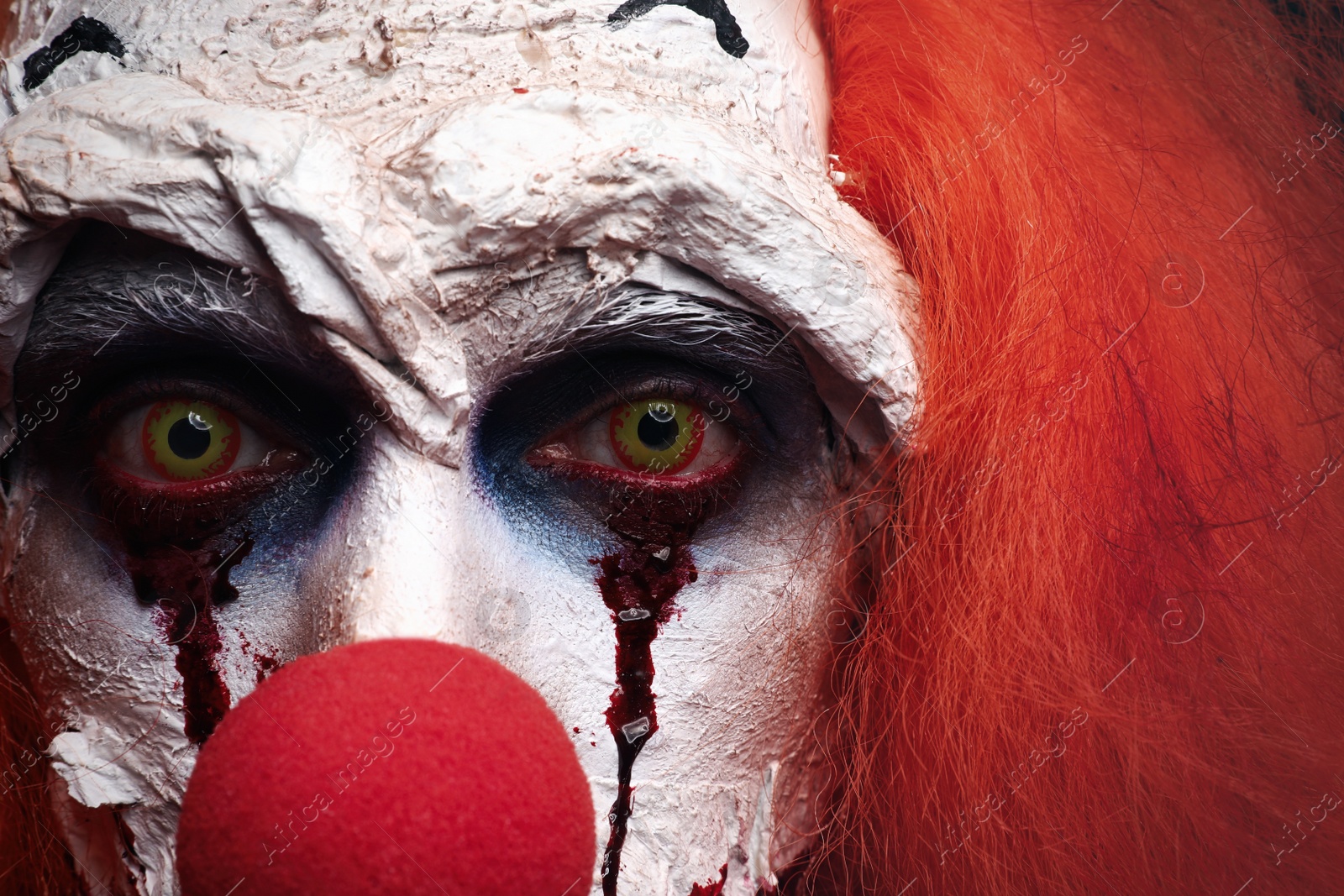 Photo of Terrifying clown, closeup view. Halloween party costume