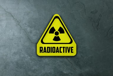 Image of Radioactive sign on grey stone wall. Hazard symbol